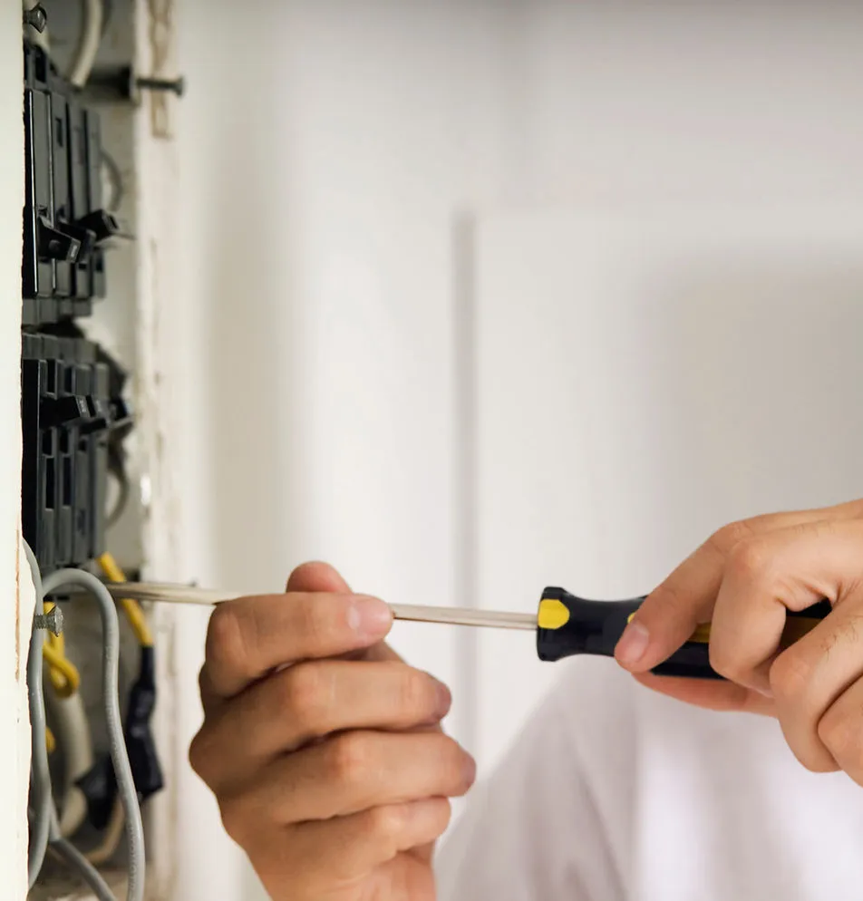 Licensed electrician installing a circuit breaker in a residential panel